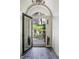 A welcoming front entry showcases a glass door, tiled floor, and courtyard beyond at 2107 Ridge Plaza Dr, Castle Rock, CO 80108