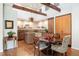 Modern kitchen with granite countertops, wood floors, custom cabinets and elegant dining area at 2107 Ridge Plaza Dr, Castle Rock, CO 80108