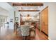 Inviting kitchen and dining area with hardwood floors, wood beam, and ample cabinet space at 2107 Ridge Plaza Dr, Castle Rock, CO 80108