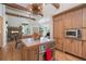 Spacious kitchen featuring a center island, built-in appliances and exposed wooden beams at 2107 Ridge Plaza Dr, Castle Rock, CO 80108