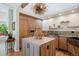 Well-designed kitchen featuring custom cabinets, center island, stone backsplash and unique lighting at 2107 Ridge Plaza Dr, Castle Rock, CO 80108