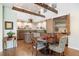 Well-lit kitchen and dining area with custom cabinets, granite countertops, and wood floors at 2107 Ridge Plaza Dr, Castle Rock, CO 80108