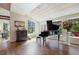 Spacious living room showcasing hardwood floors, beamed ceilings, and a grand piano at 2107 Ridge Plaza Dr, Castle Rock, CO 80108