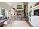 Open-concept living room with modern decor, fireplace and easy access to other rooms at 2107 Ridge Plaza Dr, Castle Rock, CO 80108