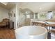 Bright main bathroom featuring a soaking tub, glass enclosed shower, and double vanity sinks at 2107 Ridge Plaza Dr, Castle Rock, CO 80108