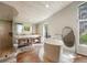 Bright main bathroom with soaking tub, dual sinks, large windows, and separate glass shower at 2107 Ridge Plaza Dr, Castle Rock, CO 80108