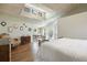 Light-filled main bedroom with vaulted ceiling, skylights, hardwood floors, and adjoining bathroom at 2107 Ridge Plaza Dr, Castle Rock, CO 80108