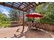 Charming patio with stone flooring, a wooden pergola, outdoor seating, and mountain views at 2107 Ridge Plaza Dr, Castle Rock, CO 80108