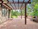 Relaxing patio with a stone privacy wall, pergola, and flagstone pavers at 2107 Ridge Plaza Dr, Castle Rock, CO 80108