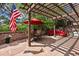 Inviting patio with a pergola, stone walls, outdoor seating, and a vibrant red umbrella at 2107 Ridge Plaza Dr, Castle Rock, CO 80108