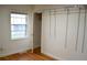 Bedroom with hardwood floors, a window, closet, and closet organizers at 1300 Spruce St, Denver, CO 80220