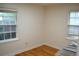 Empty room with hardwood floors, windows, base trim, and closet at 1300 Spruce St, Denver, CO 80220