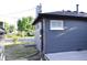 Side view of home highlighting gray paint, white trim, and well-maintained roof at 1300 Spruce St, Denver, CO 80220