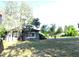 Charming home with mature trees and a spacious front yard, freshly painted with white trim at 1300 Spruce St, Denver, CO 80220