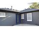Back of house showing storm windows, gray paint, blue back door and well-maintained roof at 1300 Spruce St, Denver, CO 80220