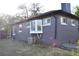 Back corner view of home highlighting gray paint, white trim, and bay window at 1300 Spruce St, Denver, CO 80220