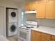 Efficient kitchen layout with stacked washer/dryer, modern appliances, and ample counter space at 1300 Spruce St, Denver, CO 80220