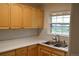 Bright kitchen featuring ample cabinet space, modern countertop, and a stainless-steel sink under a window at 1300 Spruce St, Denver, CO 80220