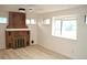Cozy living room with a brick fireplace, a ceiling fan, and natural light streaming through the windows at 1300 Spruce St, Denver, CO 80220