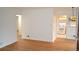 Open living room with gleaming hardwood floors and a view into the kitchen, creating a seamless flow at 1300 Spruce St, Denver, CO 80220