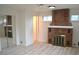 Cozy main bedroom with a brick fireplace, large windows, neutral paint, and a mirrored closet door at 1300 Spruce St, Denver, CO 80220