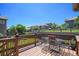 Outdoor deck featuring metal table and seating with backyard view at 22002 E Irish Dr, Aurora, CO 80016
