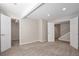 Spacious carpeted basement with multiple doorways and ample lighting, offering versatility for various living arrangements at 22002 E Irish Dr, Aurora, CO 80016
