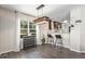 Bright dining area with stylish lighting, hardwood floors, and view into kitchen at 22002 E Irish Dr, Aurora, CO 80016