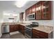 Gourmet kitchen featuring stainless steel appliances, custom cabinetry, and granite countertops at 22002 E Irish Dr, Aurora, CO 80016