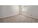 Unfurnished room with a large window and neutral carpeting, providing a blank canvas for new owners to personalize at 22002 E Irish Dr, Aurora, CO 80016