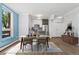 Dining area with wood table, modern chairs, and updated kitchen with stainless appliances at 320 S Ames St # 5, Lakewood, CO 80226