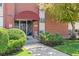 The apartment's front entrance features manicured bushes and an awning above a metal security door at 320 S Ames St # 5, Lakewood, CO 80226