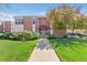 Inviting brick apartment building featuring a well-manicured lawn and charming walkway to the front entrance at 320 S Ames St # 5, Lakewood, CO 80226