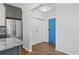 Hallway with modern flooring, coat closet, and view to bright turquoise door at 320 S Ames St # 5, Lakewood, CO 80226
