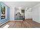 Bright kitchen area with stainless appliances, white cabinets, hardwood floors, and modern lighting at 320 S Ames St # 5, Lakewood, CO 80226