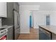 Updated kitchen featuring stainless steel refrigerator and granite countertop at 320 S Ames St # 5, Lakewood, CO 80226