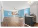Bright living area with large windows, hardwood floors, wet bar with granite counters, and ceiling fan at 320 S Ames St # 5, Lakewood, CO 80226