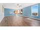 Light-filled living room with large windows, hardwood floors, and a ceiling fan at 320 S Ames St # 5, Lakewood, CO 80226
