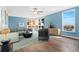 Bright living room with large windows, hardwood floors, ceiling fan, and comfortable furniture at 320 S Ames St # 5, Lakewood, CO 80226