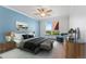 Spacious main bedroom featuring a large window with natural light, stylish furniture, and wood floors at 320 S Ames St # 5, Lakewood, CO 80226