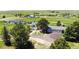 Expansive aerial view of the property, showcasing the home, landscaping, detached garage, and surrounding acreage at 45321 Summit Rd, Parker, CO 80138