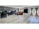 Finished basement with wood-look floors, media area, sofa, and double door access to the exterior at 45321 Summit Rd, Parker, CO 80138