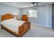 Spacious bedroom with plush carpet, natural light, and an ornate wooden bedframe at 45321 Summit Rd, Parker, CO 80138