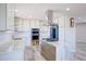Modern kitchen with an island, stainless steel appliances, and white subway tile backsplash at 45321 Summit Rd, Parker, CO 80138