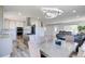 Open-concept kitchen and dining area with an island, stainless steel appliances and wood-look floors at 45321 Summit Rd, Parker, CO 80138