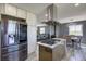 Open-concept kitchen with stainless steel appliances, a center island, and modern lighting at 45321 Summit Rd, Parker, CO 80138