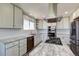Bright and modern kitchen with stainless steel appliances, and white cabinetry at 45321 Summit Rd, Parker, CO 80138