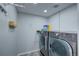 Bright laundry room with modern front loading washer and dryer at 45321 Summit Rd, Parker, CO 80138