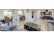 Open-concept living area featuring wood-look floors, a stylish kitchen, and comfortable seating at 45321 Summit Rd, Parker, CO 80138
