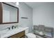 Stylish powder room with a marble countertop, dark wood vanity, and neutral gray paint at 45321 Summit Rd, Parker, CO 80138